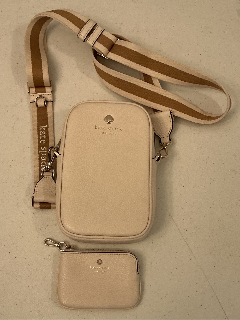 kate spade cream crossbody camera bag with tan striped strap